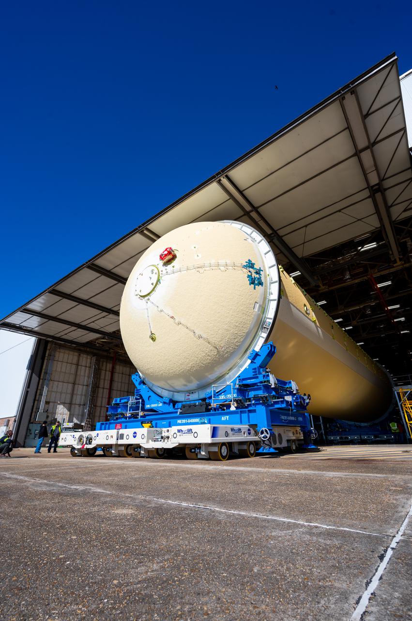Technicians transported the assembled upper part of the Artemis II core stage to the final assembly area inside the factory at NASA’s Michoud Assembly Facility in New Orleans.  On Jan 10, the forward assembly, left was moved next to the Artemis II liquid hydrogen tank, which has been undergoing assembly. Next, Boeing, the lead core stage contractor, will join the forward assembly and the liquid hydrogen tank to complete most of the core stage for the Space Launch System (SLS) rocket that will send the first crew on an Artemis mission. The core stage consists of five major structures that are built, outfitted, and then connected to form the final stage. The forward skirt, liquid oxygen and intertank were connected and tested to form the 66-foot forward assembly. After the forward assembly is joined with the 130-foot liquid hydrogen tank, only the engine section, the fifth piece of the stage, will need to be added to complete the Artemis II core stage.  The core stage serves as the backbone of the rocket, supporting the weight of the payload, upper stage, and crew vehicle, as well as the thrust of its four RS-25 engines and two five-segment solid rocket boosters attached to the engine and intertank sections. On Artemis II, the SLS rocket will launch the Orion spacecraft and a crew, sending them into lunar orbit, in preparation for later Artemis missions that will enable the first woman and first person of color to land on the Moon.
